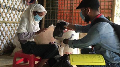 A medical volunteer tends to a refugee