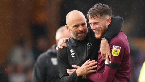 Derby manager Paul Warne hugs midfielder Max Bird