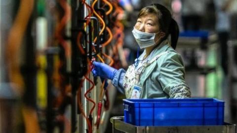 A woman works in Everwin precision technology factory in Dongguan, Guangdong Province, China