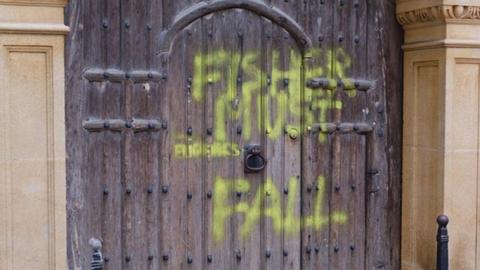 Spray paint on the Gate of Honour at Gonville & Caius College