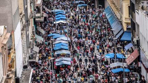 Customers in busy street making purchases in Sao Paulo, Brazil, on December 2, 2018