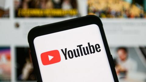 a YouTube logo seen displayed on a smartphone