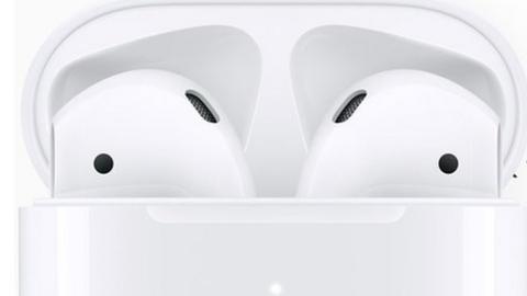 The new AirPods with Siri support shown in front of an iPhone screen