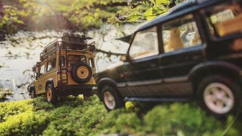 Model Land Rovers by a river