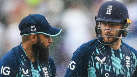 Adil Rashid (left) and Jos Buttler (right) walk off at Headingley