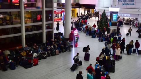 A queue snakes around Gatwick airport