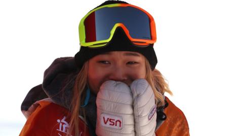 Chloe Kim celebrating after her run in the Snowboard Women's Halfpipe Final