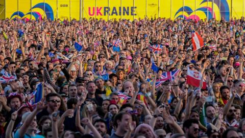 Eurovision fans watch the Eurovision Song Contest final on a giant screen in the Eurovision Village on May 13