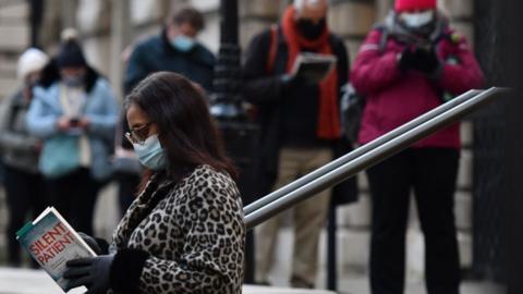 People queueing for vaccination i n London