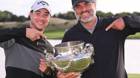 Guido Migliozzi and his caddie Alberto Villanueva pose with the trophy after winning the Open de France at Le Golf National