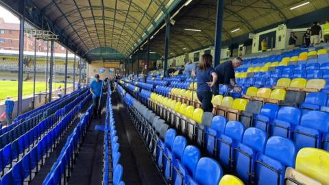 Southend United fans clearing up Roots Hall Stadium