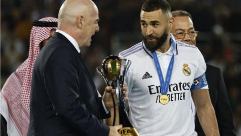 Fifa president Gianni Infantino presents the Fifa Club World Cup to Real Madrid's Karim Benzema