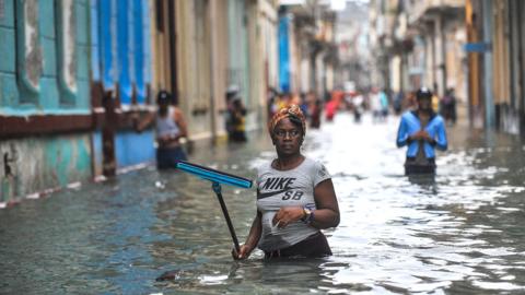 Woman in floodwater in Havana