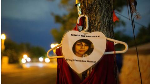 On a tree out front of Camp Marcedes, located next to the Canadian Museum for Human Rights, a photo and red dress signify the loss of Marcedes Myran with a call to action in searching the landfills for her remains