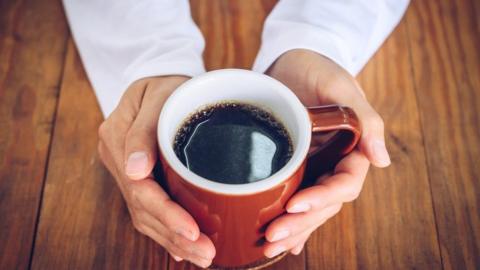 Hands warmed on coffee cup