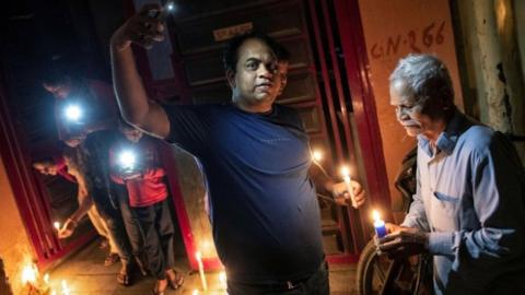 Residents light candles and turn on mobile phone torches in India