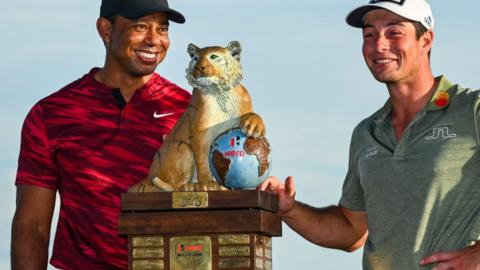 Tiger Woods presents Hero World Challenge trophy to Viktor Hovland