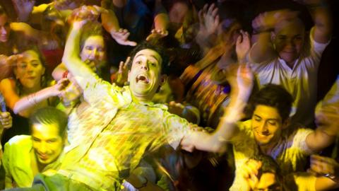 A music fan jumping in a moshpit