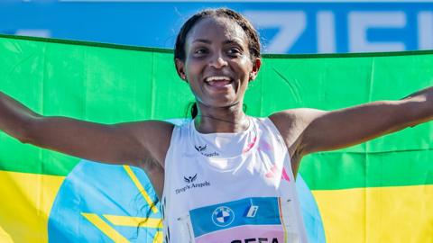 Ethiopia's Tigist Assefa celebrates her women's world record run at the 2023 Berlin Marathon