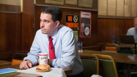 Wisconsin Governor Scott Walker eats a burger.