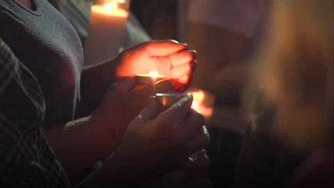 Candle being held at vigil