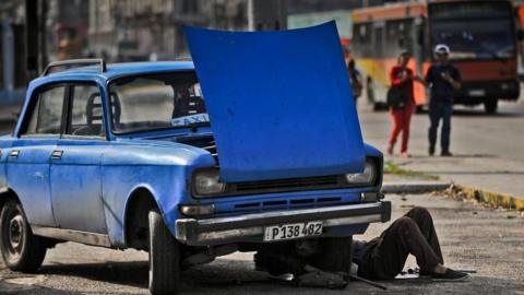 Man fixing car