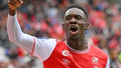 Folarin Balogun celebrates a goal for Reims