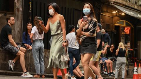 People sit and drink outside a bar in Hong Kong on 15 November