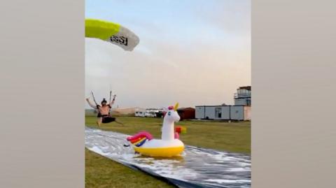 Skydiver lands on inflatable