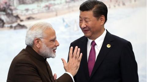 Indian Prime Minister Narendra Modi (L) greets Chinese President Xi Jinping (R) prior to the dinner on September 4, 2017