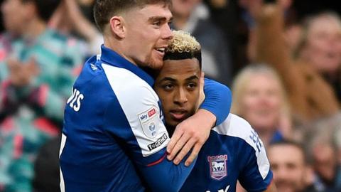 Omari Hutchinson is congratulated by team-mate Leif Davis