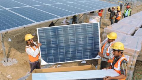 Indian workers construct part of the France-India Solar Direct Punjab Solar Park project in Muradwala