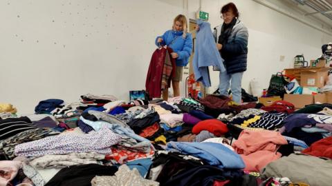 Refugee Nataliya alongside her aunt, Iren sorting donated clothes at the Shropshire Supports Refugees centre