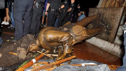 University of North Carolina police surround the toppled statue of a Confederate soldier nicknamed Silent Sam