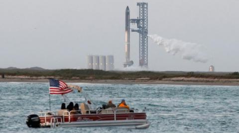 Spectators watch from a boat before SpaceX's Starship lifts off from the company's Boca Chica launchpad on an orbital test mission near Brownsville, Texas, U.S., April 17, 2023.