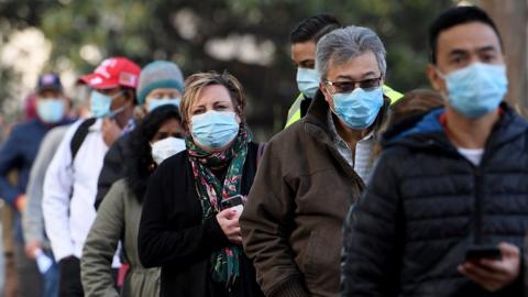 People in Sydney queuing for vaccines during the city's lockdown