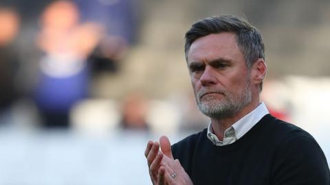 Graham Alexander applauds MK Dons fans at the end of his tenure with the club