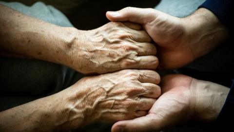 Hands being held in a care home