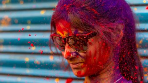 Indian Hindu devotees celebrates holi with colorful powders during the Holi festival in Kolkata. Holi is a popular Hindu festival filled with so much fun and is celebrated to mark the beginning of spring. Idols of Lord Krisha and Radha being carried on a vintage Rolls-Royce car returning to the Shri Shri Satyanarayan Bhagwan Ji Ka Mandir at Burrabazar in Kolkata, on 5th March 2023.