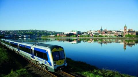 A train travelling along the waterfront in Londonderry