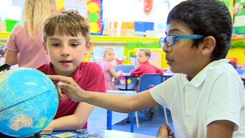 Children looking at a globe