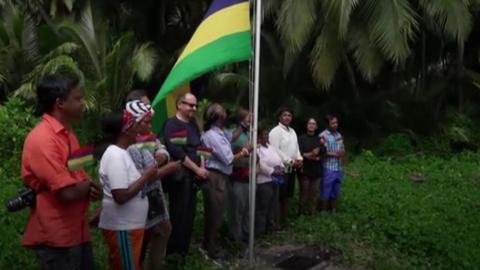 Mauritian flag being raised at Chagos Islands