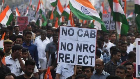 Supporters and activists of Trinamool Congress (TMC) participate in a mass rally attended by Chief minister of West Bengal state and leader of the Trinamool Congress (TMC) Mamata Banerjee (unseen), to protest against the Indian government"s Citizenship Amendment Act (CAA) in Kolkata on December 17, 2019. -