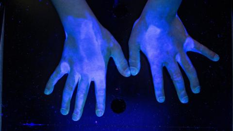 Hands under UV light