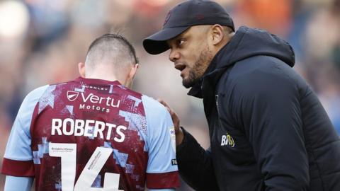 Burnley manager Vincent Kompany chats to Connor Roberts