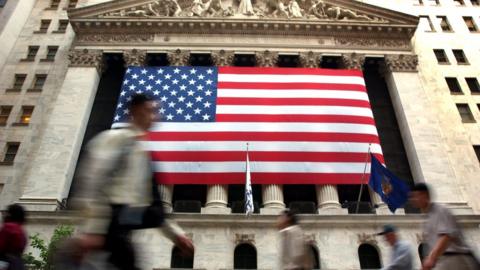 Man walking past stock exchange