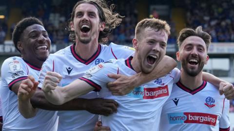 Bolton players celebrate their fifth goal against Ipswich Town