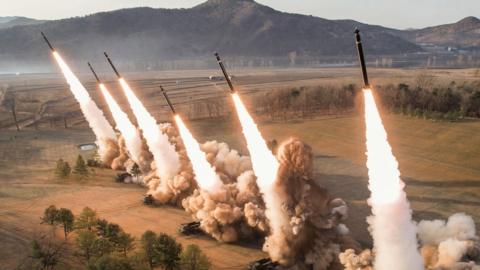 Multiple rocket launchers firing in North Korean drill overseen by Kim Jong Un