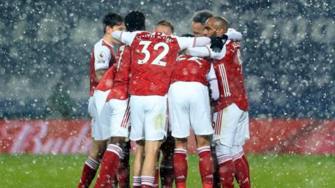 Arsenal players huddle together