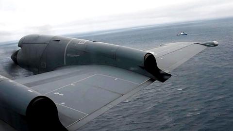 A Royal Canadian Air Force CP-140 Aurora maritime surveillance aircraft of 14 Wing flies a search pattern for the missing OceanGate submersible
